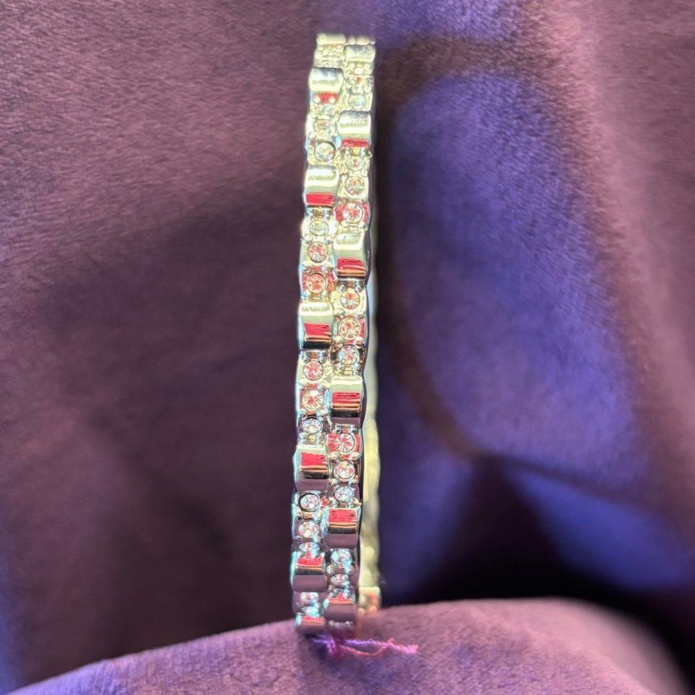 Bracelet features a stretchy silver band that comfortably fits around the wrist